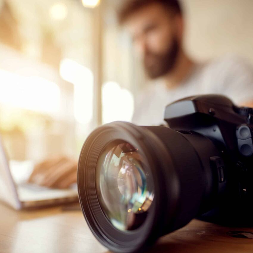 Photographer,Off,Loading,Files,On,Laptop.,Checking,Photos,Working,At Camera On Desk